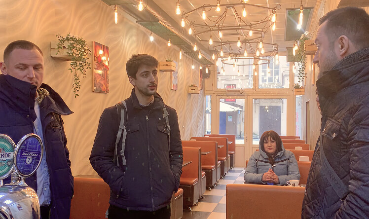 Team conducting a user interview with a customer inside a bar in St. Petersburg