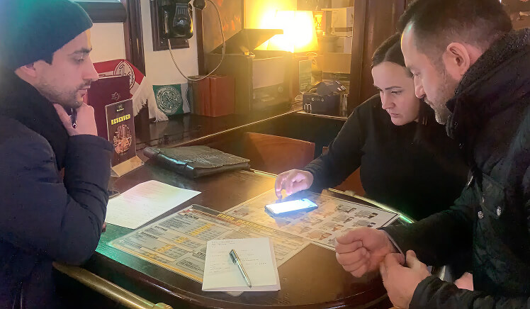 Researcher observing a customer interacting with a mobile shop app during a user interview in St. Petersburg